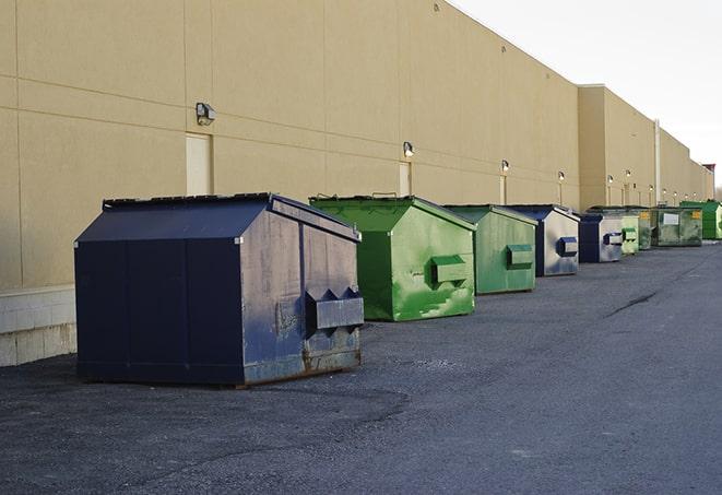 multiple construction dumpsters at a worksite holding various types of debris in Brant, NY